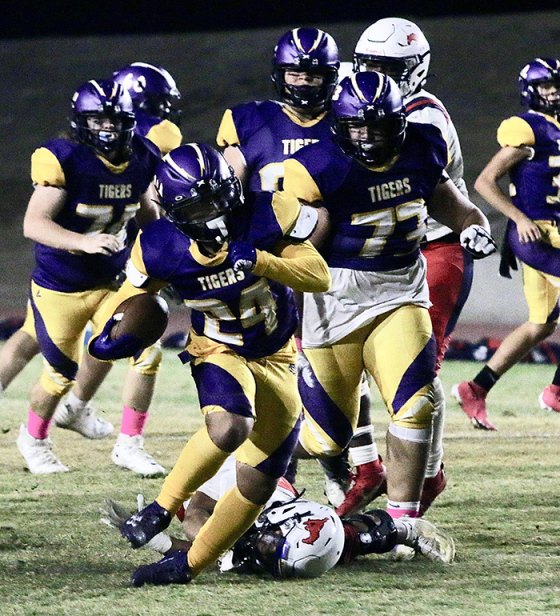 Lemoore's Terren McCoy follows blockers on a way to a short gain in the third quarter of Friday night's game against Tulare Western.
